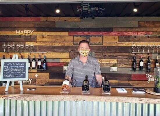 Charles McKahn serving McKahn Cellars’ wines during happy hour at Feast It Forward