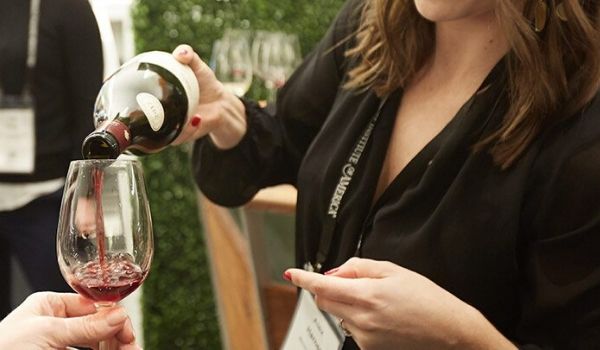 Woman pouring wine at CIA summit