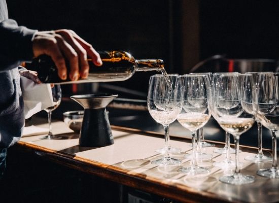 sommelier pouring wine